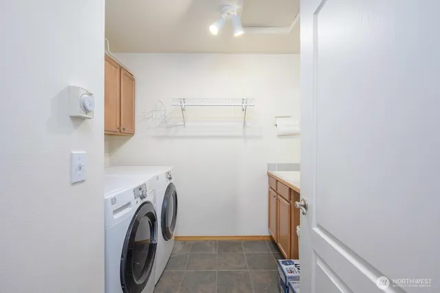 a view of storage and utility room with washer and dryer