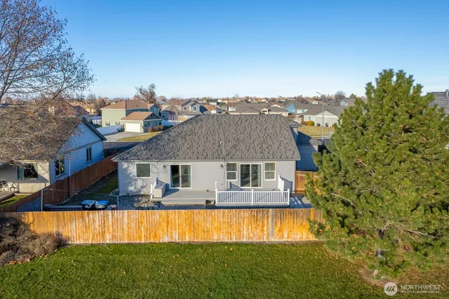 a front view of house with yard and trees in the background