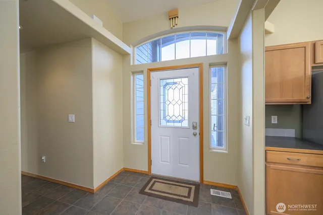 a view of an entryway with wooden floor