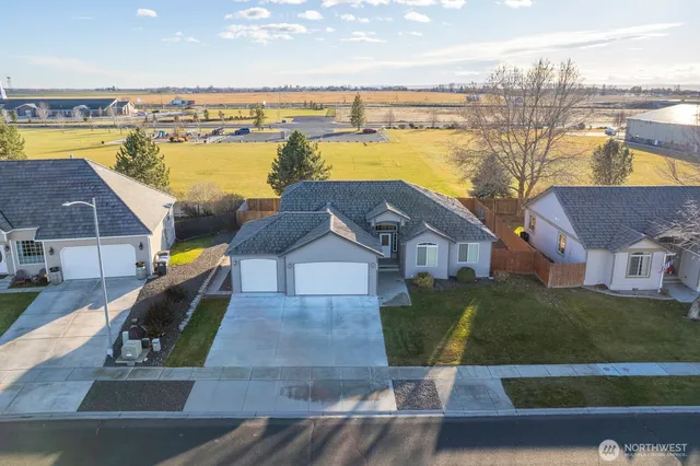 an aerial view of residential houses with outdoor space and ocean view