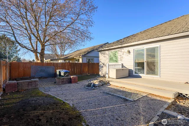 a view of a backyard with furniture and floor to ceiling window