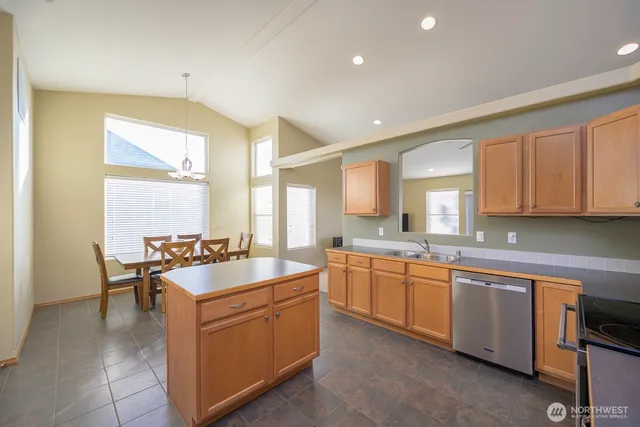 a large kitchen with a sink and cabinets