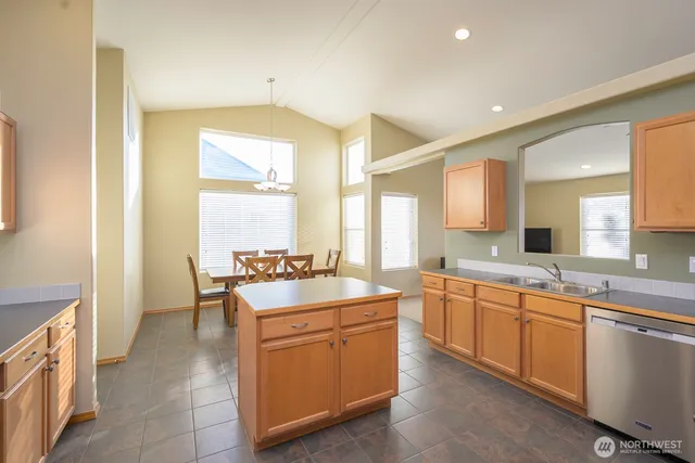 a large bathroom with a sink mirror and a bathtub