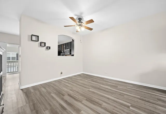 a view of an empty room with wooden floor