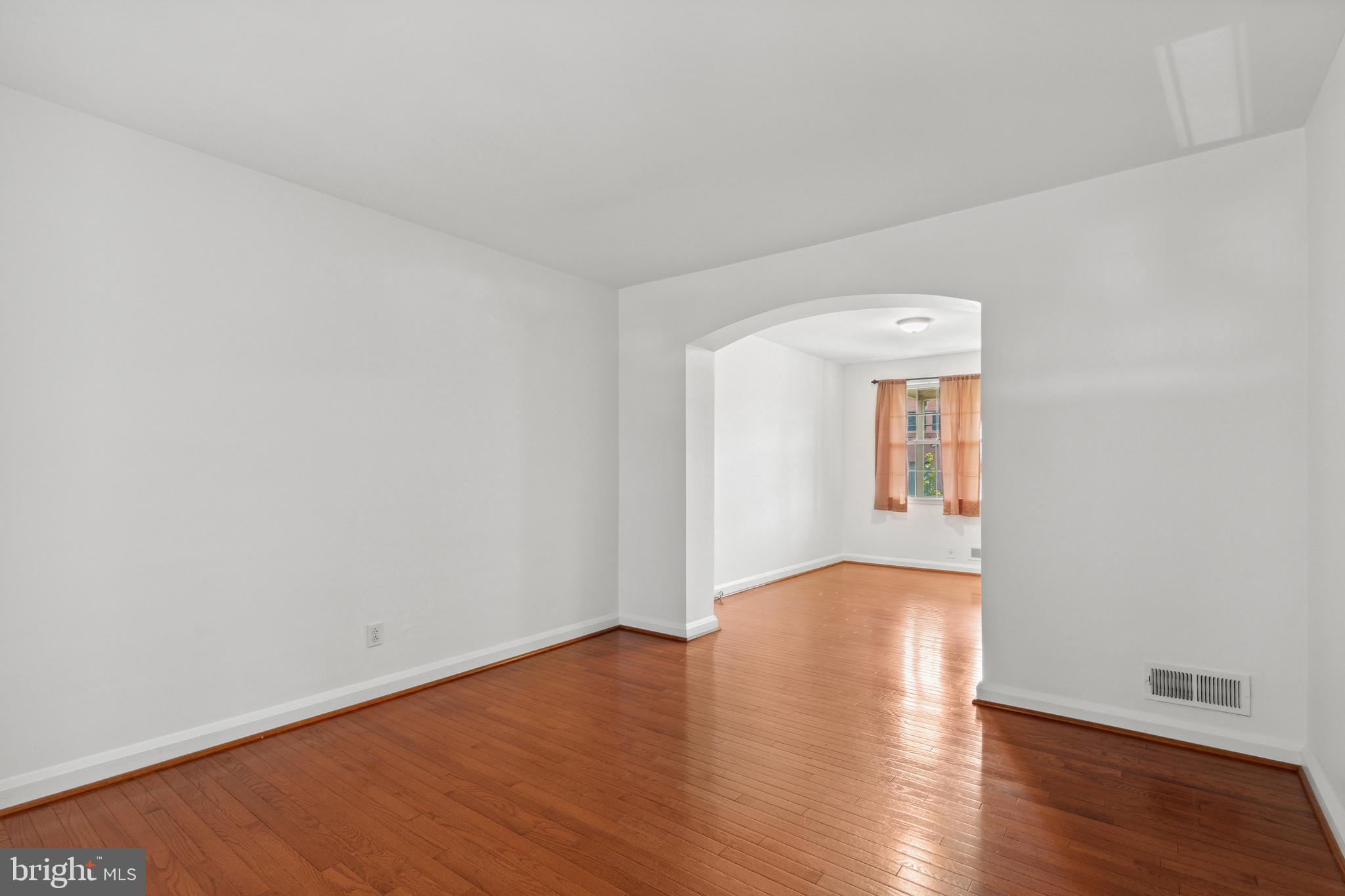3418 Dunran Road Dundalk, MD 21222 - Photo 14 of 53 an empty room with wooden floor and windows