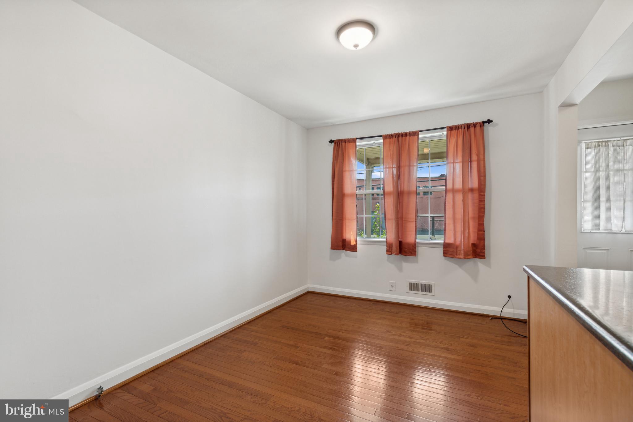 3418 Dunran Road Dundalk, MD 21222 - Photo 17 of 53 an empty room with wooden floor and windows