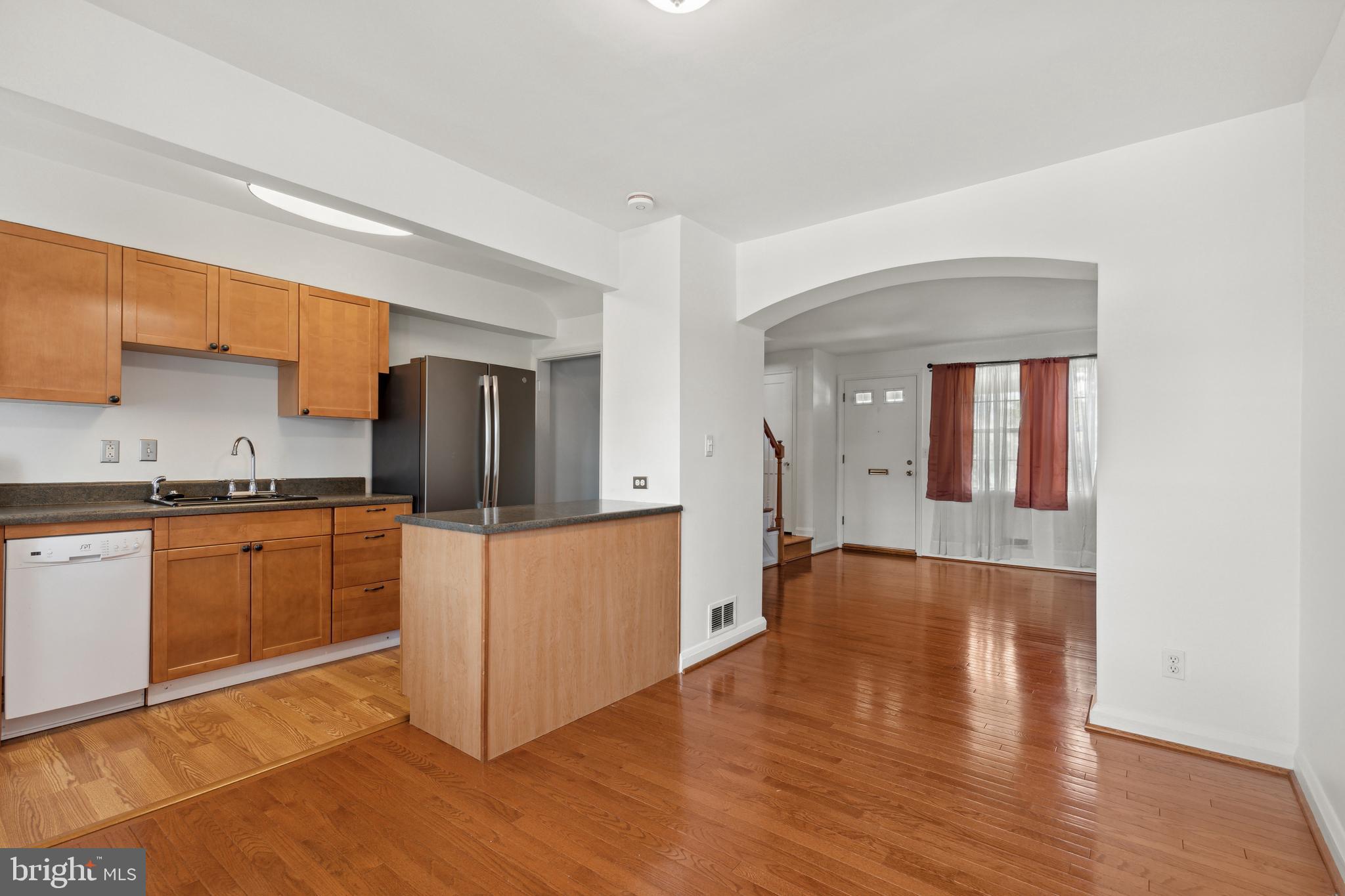 3418 Dunran Road Dundalk, MD 21222 - Photo 18 of 53 a kitchen with stainless steel appliances granite countertop a refrigerator a sink dishwasher a stove with wooden cabinets and wooden floor