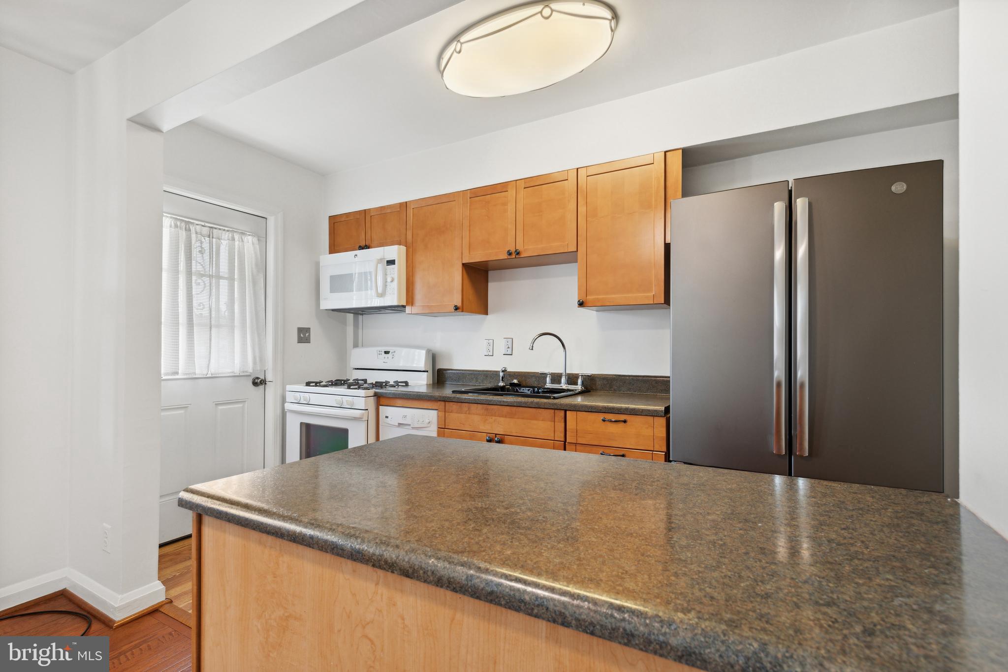 3418 Dunran Road Dundalk, MD 21222 - Photo 21 of 53 a kitchen with stainless steel appliances granite countertop a sink stove and refrigerator