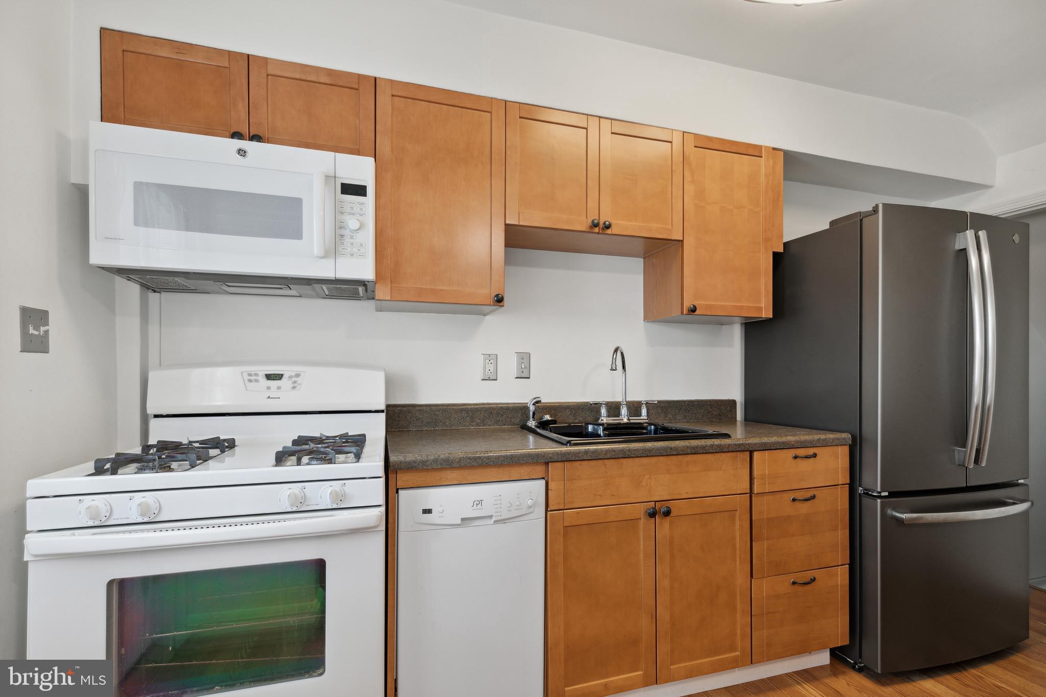 3418 Dunran Road Dundalk, MD 21222 - Photo 22 of 53 a kitchen with stainless steel appliances granite countertop a stove a refrigerator and a cabinets