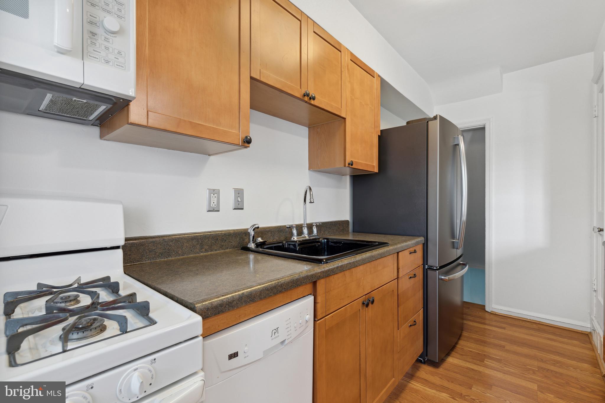 3418 Dunran Road Dundalk, MD 21222 - Photo 24 of 53 a kitchen with stainless steel appliances granite countertop a sink stove and refrigerator