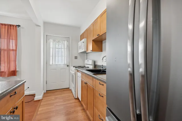 a kitchen with stainless steel appliances granite countertop a refrigerator and a stove