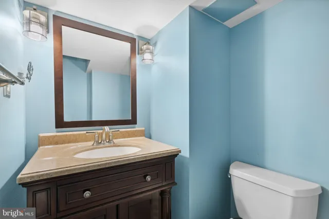 a bathroom with a sink a toilet and mirror