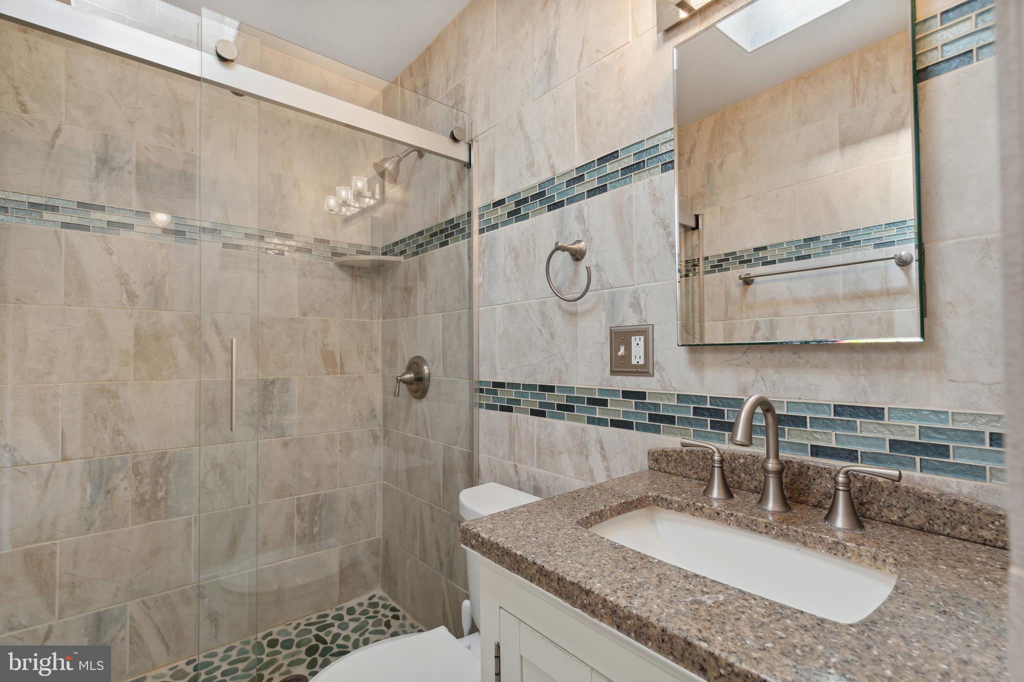 3418 Dunran Road Dundalk, MD 21222 - Photo 40 of 53 a bathroom with a granite countertop sink a mirror and shower