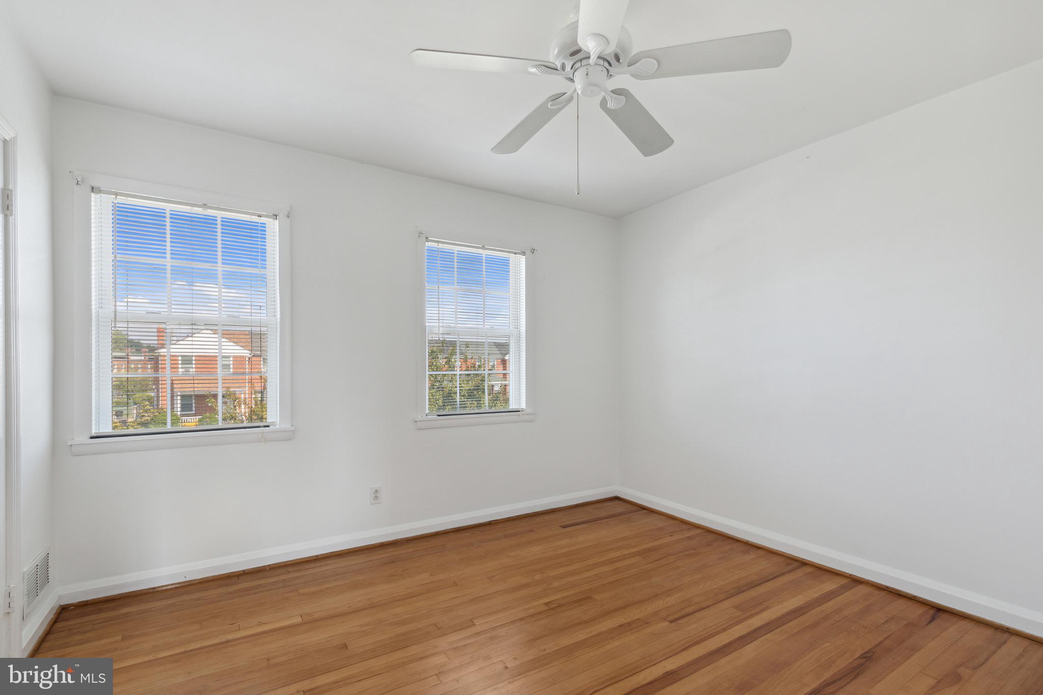 3418 Dunran Road Dundalk, MD 21222 - Photo 42 of 53 a view of an empty room with wooden floor and a window