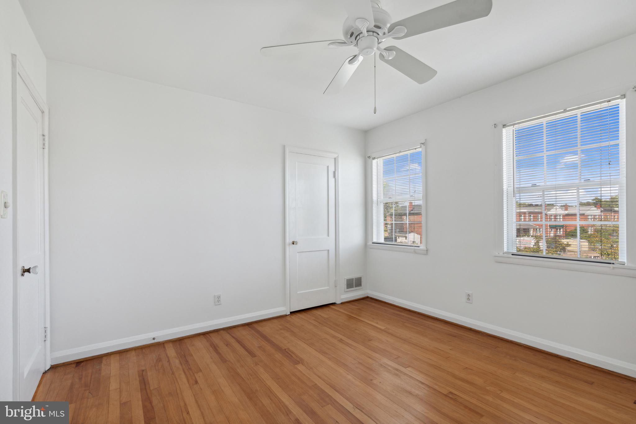 3418 Dunran Road Dundalk, MD 21222 - Photo 45 of 53 a view of an empty room with wooden floor and a window