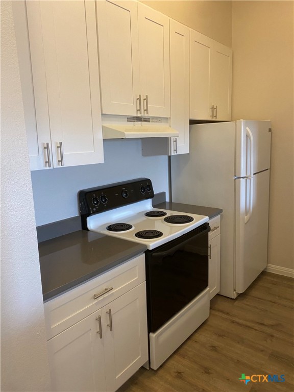 a kitchen with a stove and a refrigerator