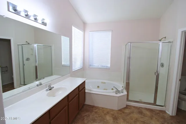 a bathroom with a tub sink and mirror