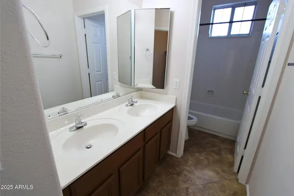 a white toilet and a bath tub sitting next to a shower