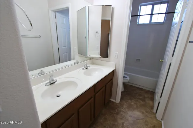 a white toilet and a bath tub sitting next to a shower