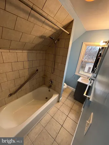 a bathroom with a tub and shower