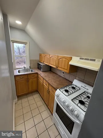 a kitchen with a stove a sink dishwasher and a stove