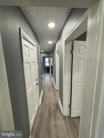 a view of hallway with wooden floor