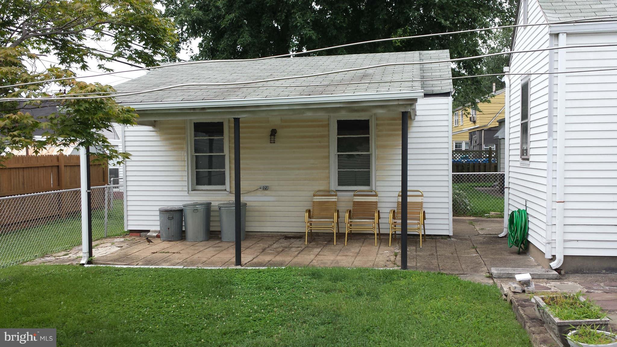 8229 Bullneck Road Baltimore, MD 21222 - Photo 3 of 10 a view of a chair and table in backyard of the house