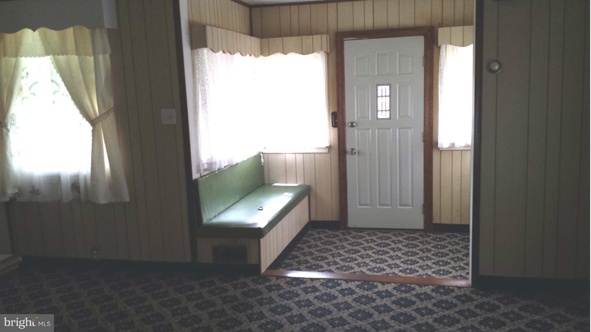 8229 Bullneck Road Baltimore, MD 21222 - Photo 5 of 10 a view of a hallway with wooden floor and a window