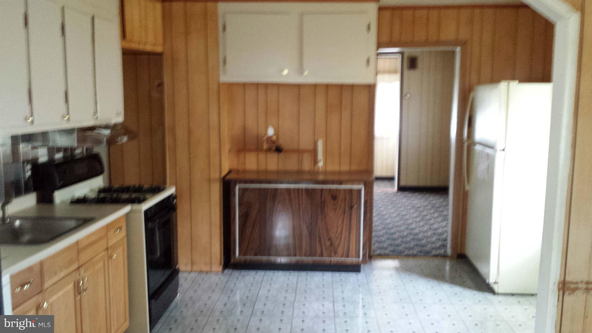 8229 Bullneck Road Baltimore, MD 21222 - Photo 8 of 10 a kitchen with granite countertop a stove and a refrigerator