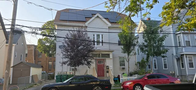 a front view of a houses with yard