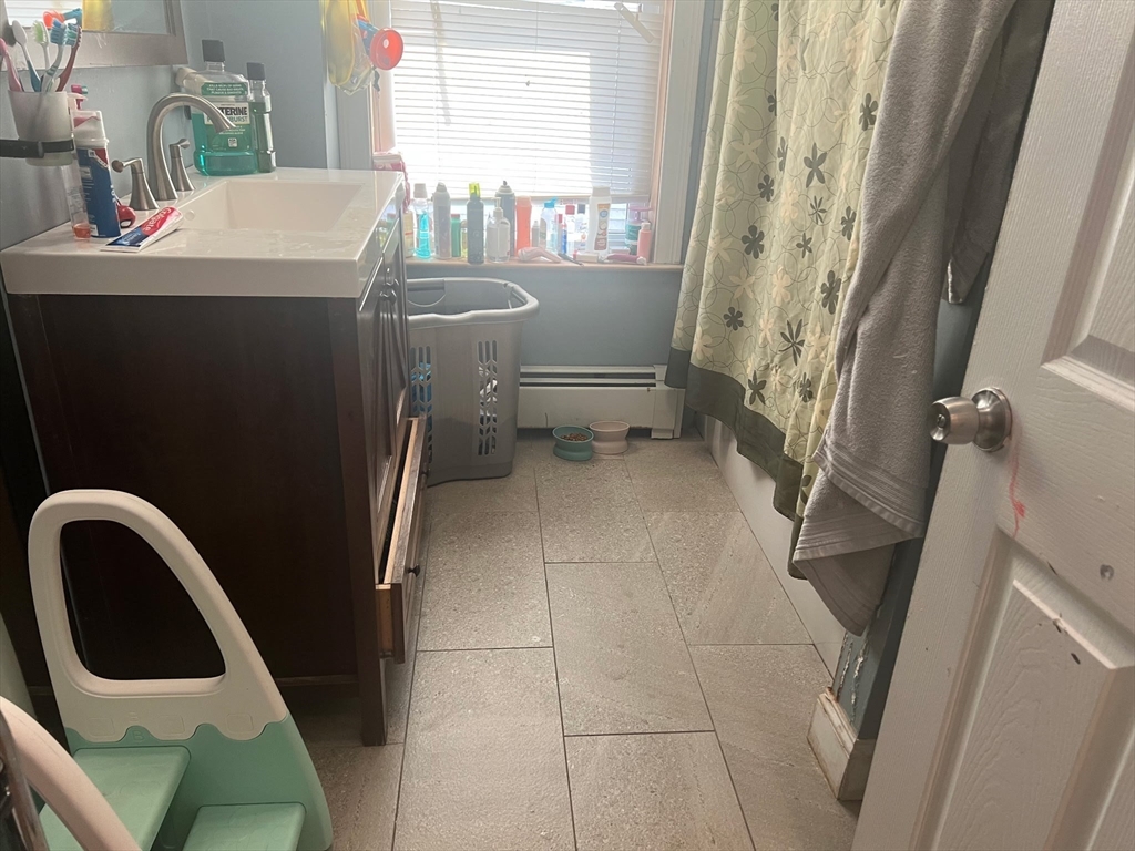 103 Warren Street Lynn, MA 01905 - Photo 12 of 24 a bathroom with a sink a toilet and shower