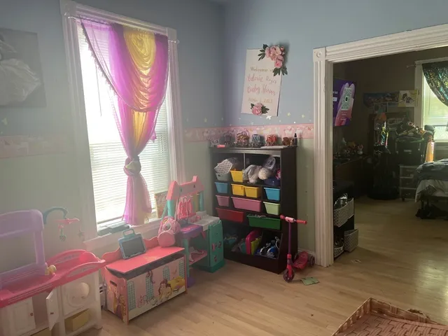 a bedroom with furniture and a window