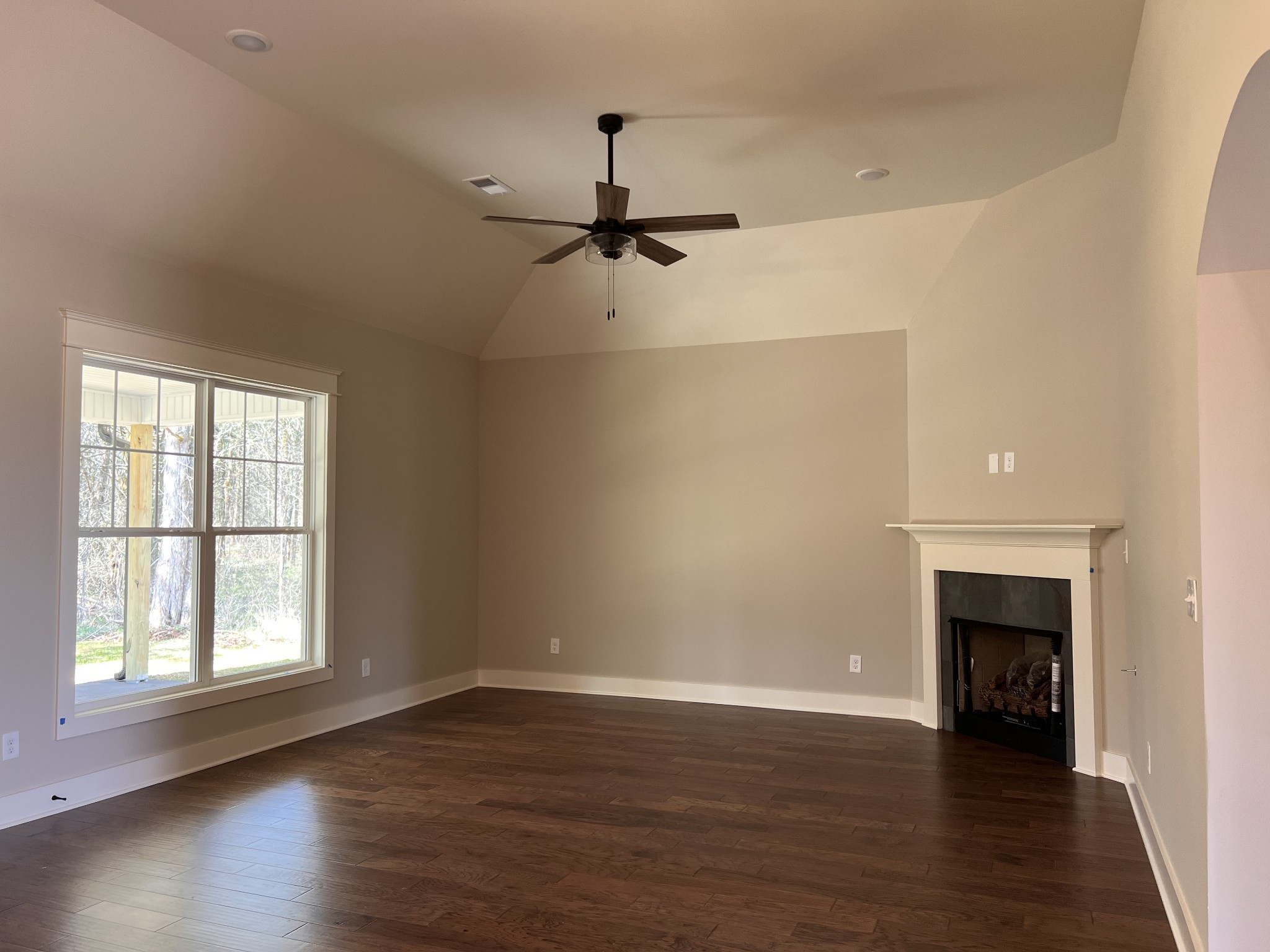 6730 Murfreesboro Road Lebanon, TN 37090 - Photo 5 of 12 an empty room with wooden floor a ceiling fan and windows