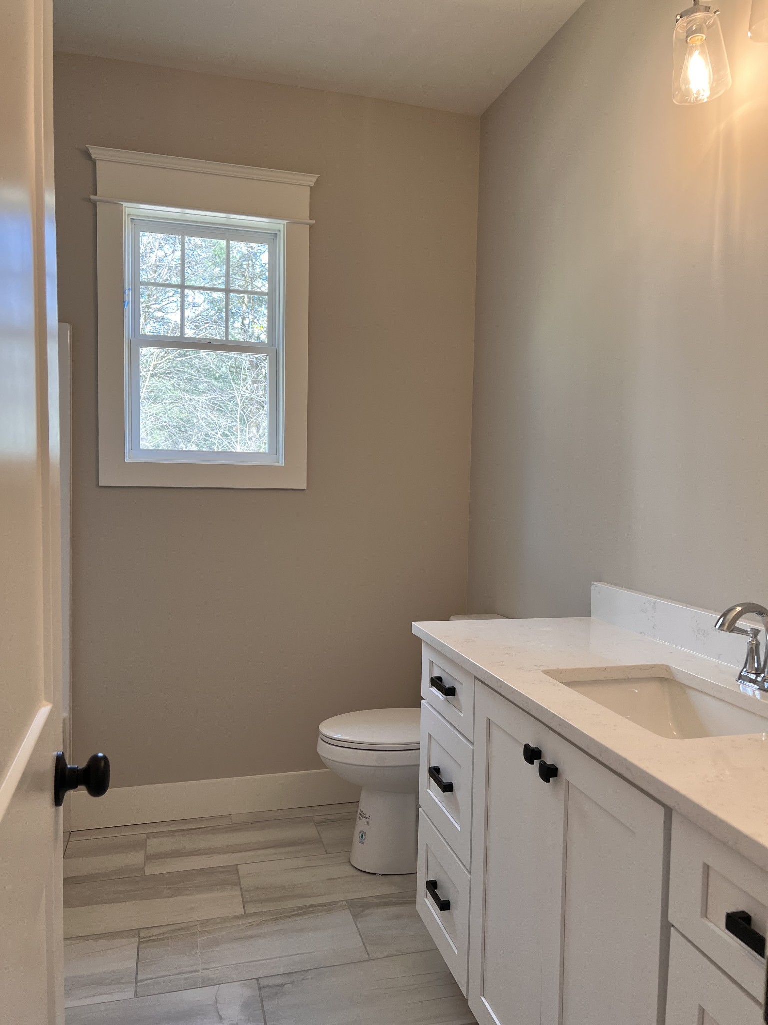 6730 Murfreesboro Road Lebanon, TN 37090 - Photo 10 of 12 a bathroom with a granite countertop toilet a sink and a window