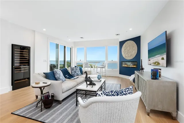 a living room with furniture a fireplace and flat screen tv