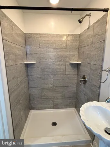 a bathroom with a sink and shower