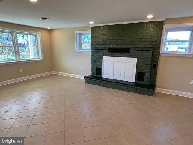 a view of empty room with a fireplace