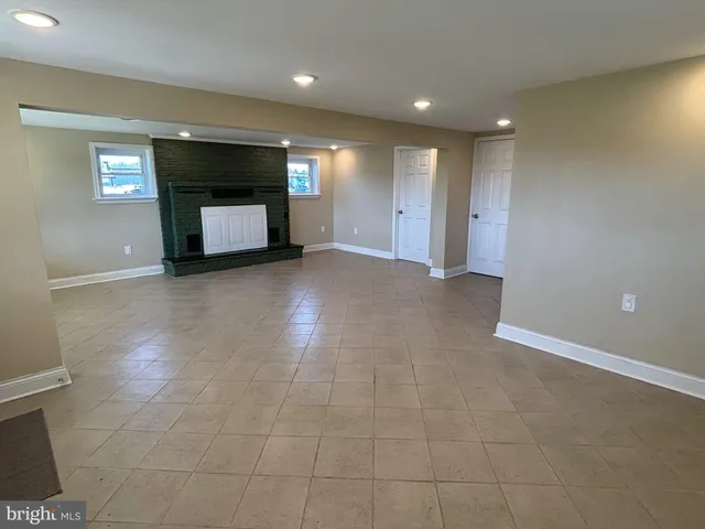 a spacious bathroom with a toilet sink and mirror