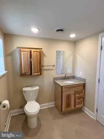 a view of a yard in front of a house with a large tree