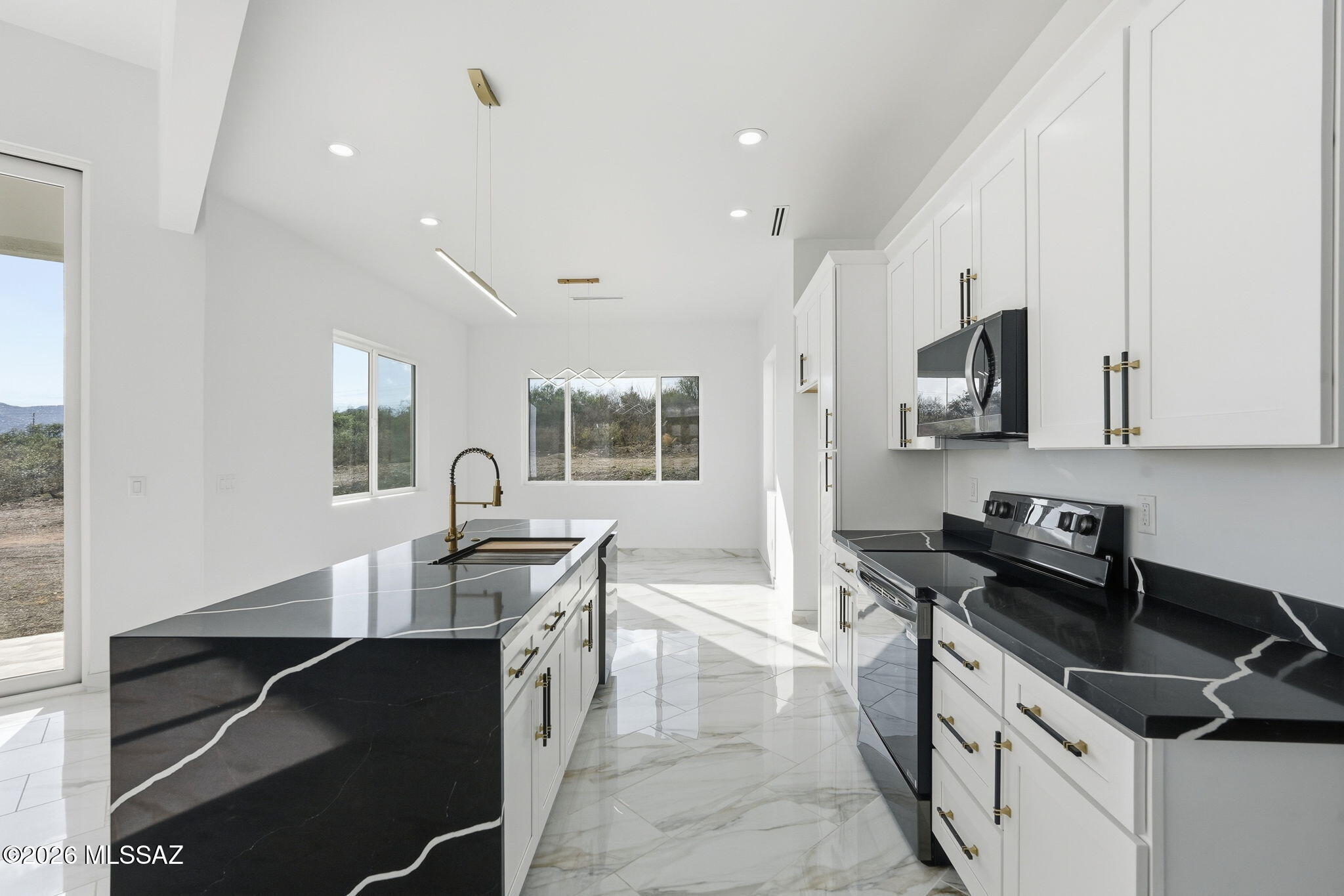1786 Peralta Court Rio Rico, AZ 85648 - Photo 15 of 50 a kitchen with a sink stove and microwave
