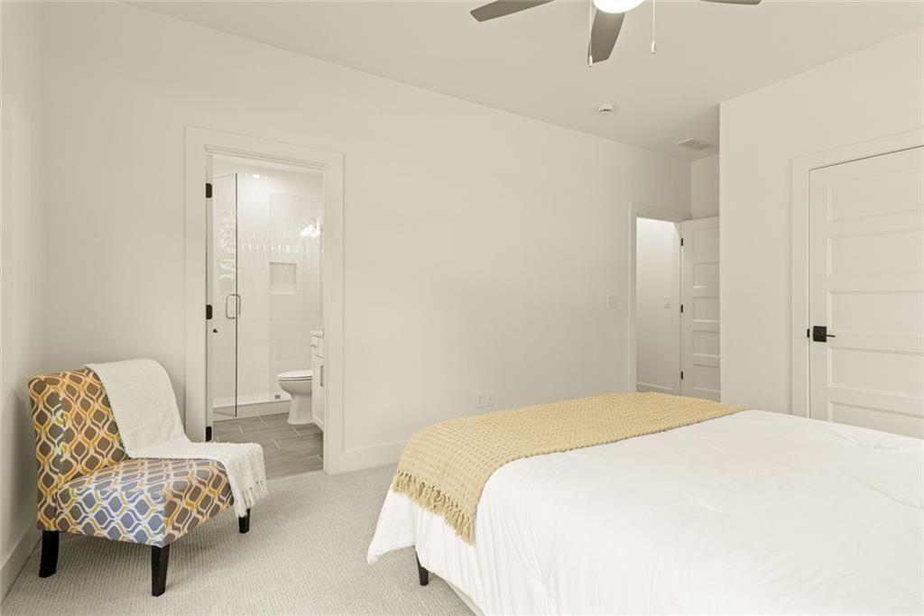 240 Highlands Ball Ground, GA 30107 - Photo 41 of 57 a bedroom with a bed and a chair