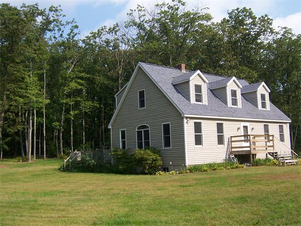 569 West Townsend Road Lunenburg, MA 01462 - Photo 1 of 18 a front view of a house with a garden