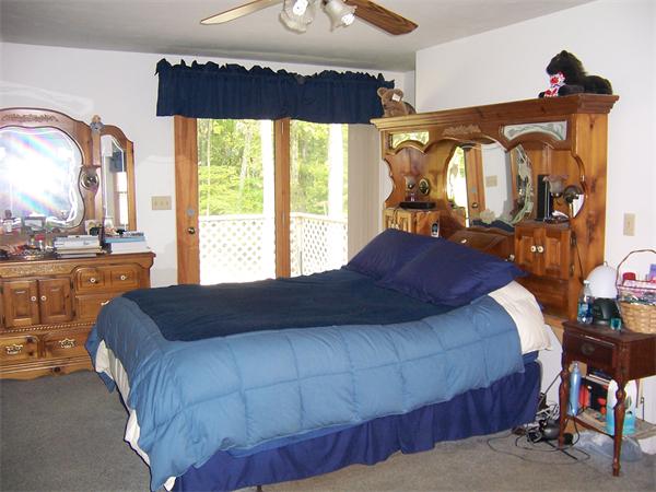 569 West Townsend Road Lunenburg, MA 01462 - Photo 13 of 18 a bed sitting in a bedroom next to a window