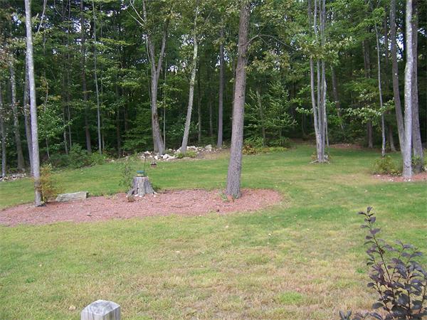569 West Townsend Road Lunenburg, MA 01462 - Photo 3 of 18 a backyard of a house with lots of green space and fountain