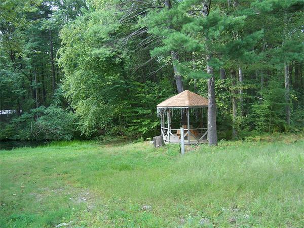 569 West Townsend Road Lunenburg, MA 01462 - Photo 5 of 18 a backyard of a house with table and chairs under an umbrella