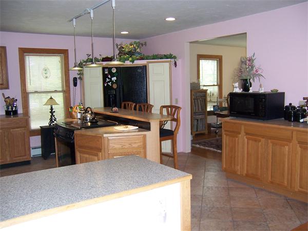 569 West Townsend Road Lunenburg, MA 01462 - Photo 9 of 18 a kitchen with stainless steel appliances kitchen island granite countertop a stove a sink and a refrigerator