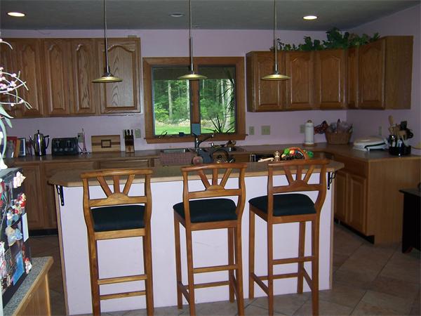 569 West Townsend Road Lunenburg, MA 01462 - Photo 10 of 18 a kitchen with stainless steel appliances granite countertop a stove a sink and a microwave