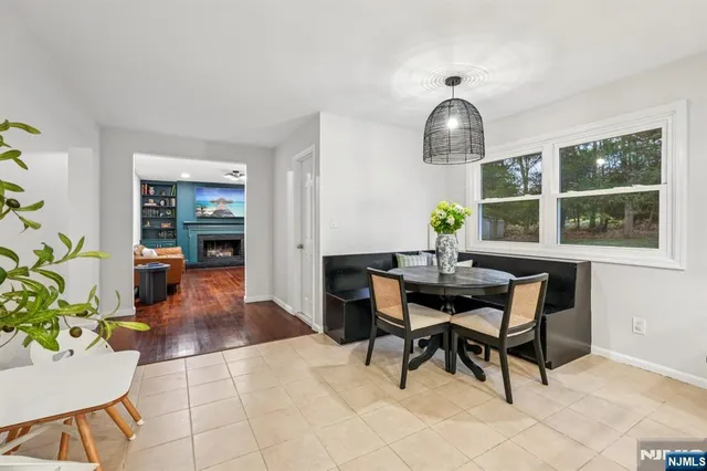 a view of a dining room with furniture and chandelier