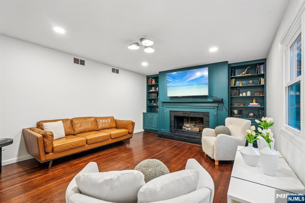 215 Readington Road Somerville, NJ 08876 - Photo 12 of 26 a living room with furniture a fireplace and a flat screen tv