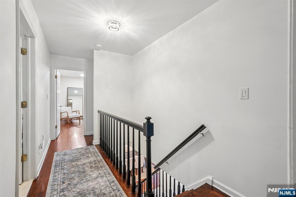 215 Readington Road Somerville, NJ 08876 - Photo 13 of 26 a view of a hallway with wooden floor and a bathroom